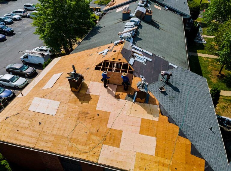 Homeowner examining roof shingles, flashing, gutters, and attic ventilation on a residential house.
